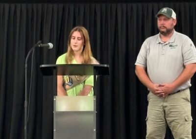 Erin speaks from the podium with Chad about the garden project