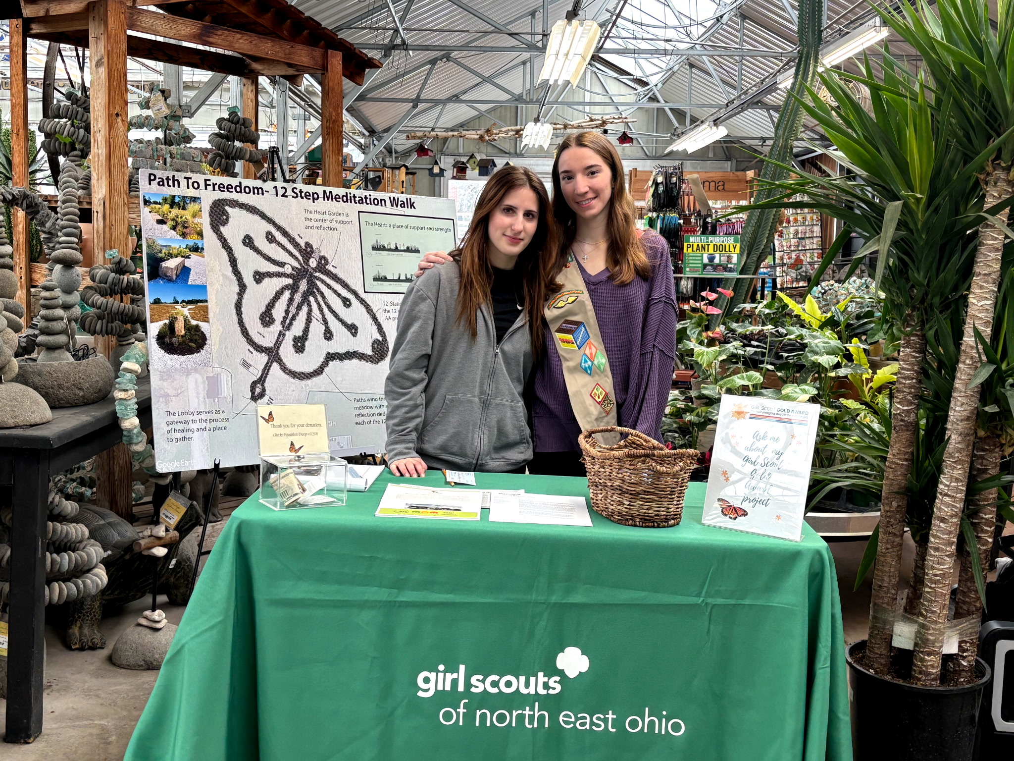 490996570747224376 Erin & Friend sharing information and collecting donations for the 12-step meditation garden at Lowe's Greenhouse Farmers Market